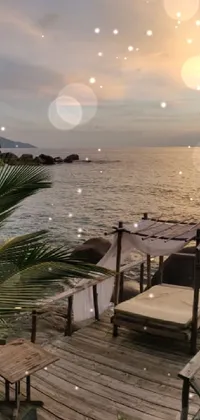 This live wallpaper features a stunning dock surrounded by water, boulders, and a beautiful sunset