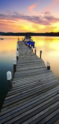 Experience the ultimate calmness with this live wallpaper of a dock by a body of water at sunset