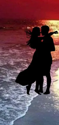 Introducing a stunning and romantic phone live wallpaper featuring a couple locked in a passionate kiss on a beautiful beach at sunset