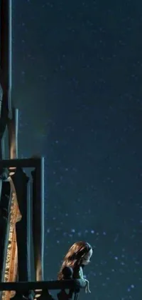 This stunning live wallpaper showcases a woman seated on a chair in front of a window, gazing up at the breathtaking night sky