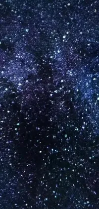This phone live wallpaper features a stunning night sky with twinkling stars, a mesmerizing microscopic image, space art and a glitter gif