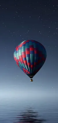 This live wallpaper features a serene night scene, with a hot air balloon beautifully flying over a calm body of water