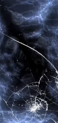 This phone live wallpaper showcases a broken glass window with a small hole revealing an enchanting microscopic photo accompanied by a bold digital art design