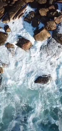Our latest live wallpaper, "Rocky Waters" features a stunning view of rocks atop a body of water