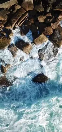 Bring the power and excitement of the ocean to your phone with this stunning live wallpaper! Watch as a surfer rides a massive wave, captured from an aerial perspective