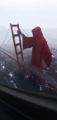 This live wallpaper features the Golden Gate Bridge, seen through the window of a moving car during a storm