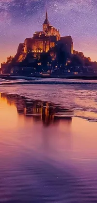 This live phone wallpaper shows a stunning castle overlooking a calm beach and the ocean