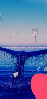 This phone live wallpaper features a stunning digital art of a whale tail in the ocean, complemented by falling hearts and an ice-cold blue theme