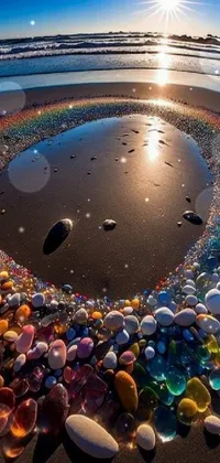 This live wallpaper by National Geographic depicts a circle of stones on a sandy beach
