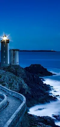 Enjoy the maritime ambiance of a lighthouse perched on a rocky cliff in this mesmerizing phone live wallpaper