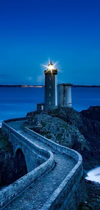 This stunning live wallpaper features a lighthouse perched on a cliff overlooking the ocean at blue hour