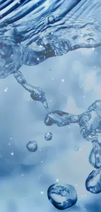 This phone live wallpaper showcases a close up of a cell phone as water spills out of it in light blue, creating a bubbly effect