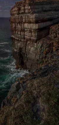 This stunning phone live wallpaper features a beautiful lighthouse situated on a majestic cliff overlooking the vast ocean