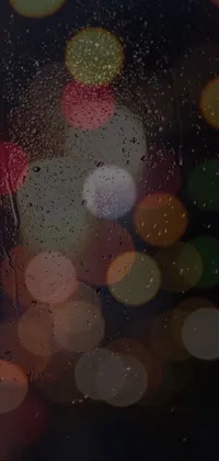 This live wallpaper is a stunning image of a rain-covered window with glowing lights in the background, perfect for an AMOLED screen