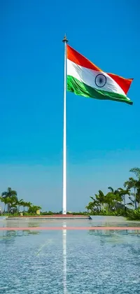 This phone live wallpaper features a large Indian flag gorgeously waving over a calm body of water, surrounded by a serene scene of Indore