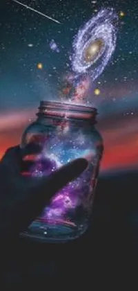 This stunning live phone wallpaper features a hand holding a glowing jar filled with a mesmerizing galaxy, creating a breathtaking display of space art