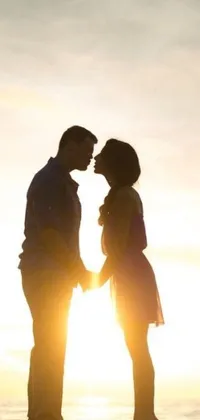 This live phone wallpaper features a romantic beach scene with a man and woman holding hands against a picture backdrop
