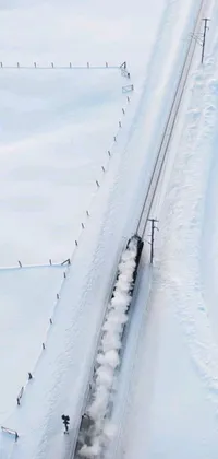 This live wallpaper features a scenic winter landscape of a train moving through snowy countryside
