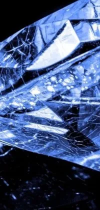 This stunning live wallpaper features a microscopic photo of a diamond on a black surface, set against an ice cold blue theme with subtle swirling patterns on a wrapped blue background