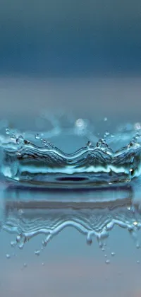 This live phone wallpaper showcases a stunning digital art rendition of a water droplet on a surface