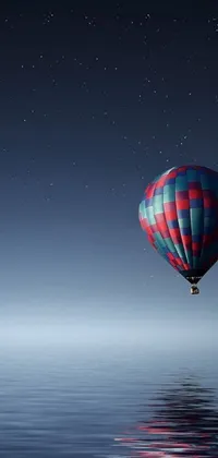 This live wallpaper features a serene scene of a hot air balloon floating over a tranquil body of water