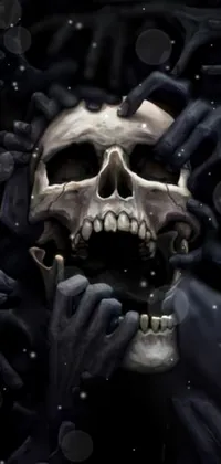 This phone live wallpaper showcases an intricately detailed skull with a black face, surrounded by ghostly hands against a backdrop of hellish scenery
