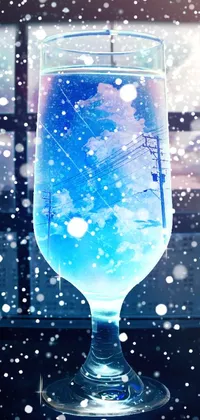This phone live wallpaper showcases a blue liquid-filled glass in front of a winter landscape view from a window