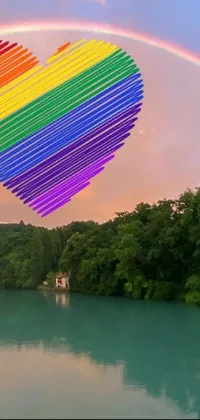 This lively and captivating phone live wallpaper displays a rainbow heart floating above a river, surrounded by the vibrant beauty of a rainbow in the sky and another in the water