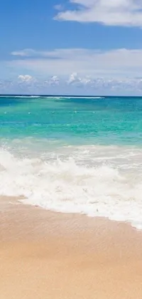 This phone live wallpaper features a nature scene with a man surfing on a sandy beach in Kauai