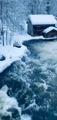 This live wallpaper showcases a winter wonderland, featuring a forest with a river, a water wheel and a distant cabin