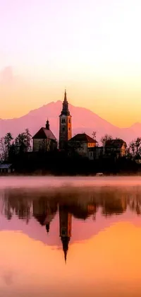 Experience serenity with a phone live wallpaper of a church sitting on a small island in a slovenian lake