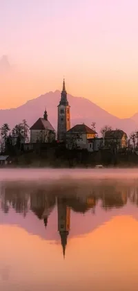 This phone live wallpaper features a picturesque church on a small island in the middle of a tranquil lake