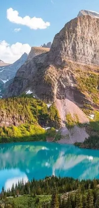 This stunning live wallpaper depicts a serene lake with a majestic mountain range in the background