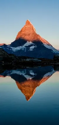 This mobile live wallpaper features a breathtaking mountain landscape reflected in still waters