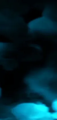 This phone live wallpaper showcases a blurry image of a figure holding a remote control, with inspiration drawn from video art, cyan fog, dark mammatus clouds, and NASA footage