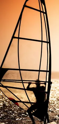This breathtaking phone live wallpaper features windsurfing in the ocean at sunset