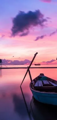 This live wallpaper showcases a serene boat sitting on a calm body of water in shades of pink and purple
