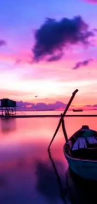 Enjoy breathtaking scenery on your phone with this live wallpaper featuring a boat on calm water amidst a beautiful purple sky