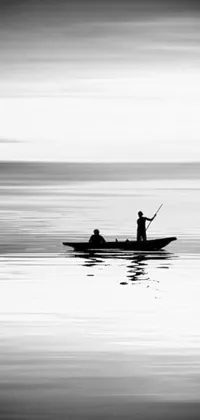 This black and white live wallpaper depicts a serene landscape with a minimalistic photo of a man in a boat, possibly fishing, and a couple in the foreground