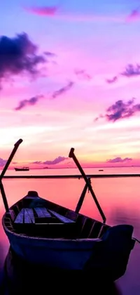 Experience a tranquil scenery with this phone live wallpaper depicting a small boat floating on calm waters