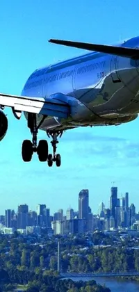 This phone live wallpaper showcases a passenger jet in flight over a bustling city skyline