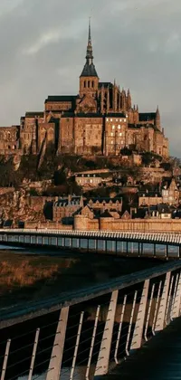 This live wallpaper showcases a picturesque bridge over water leading to a majestic castle in the background