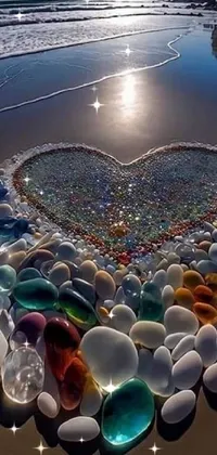 Looking for a stunning live wallpaper for your phone? Look no further than this beautiful image of a sea glass heart on the beach
