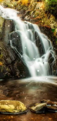 This live wallpaper for your phone showcases a stunning waterfall amidst rocky terrain