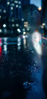 This phone live wallpaper showcases a stunning wet sidewalk in a bustling city at night
