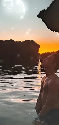 This phone live wallpaper showcases a beautiful sunset on a beach