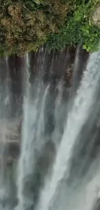 This scenic live wallpaper showcases a mesmerizing view of a water cascade from a bird's eye perspective, framed with an Instagram overlay and features a video still