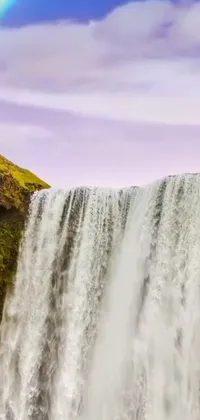 This live wallpaper for your phone is a breathtaking natural wonderland featuring a cascading waterfall and vivid rainbow