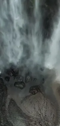Looking for an immersive phone wallpaper that brings nature to life? Check out this stunning live wallpaper featuring a mesmerizing waterfall from a drone's point of view
