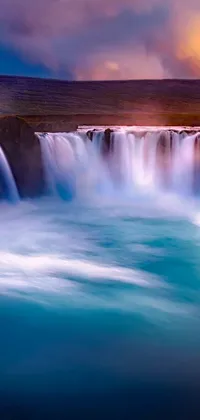 Transform your phone's screen into a picturesque and serene location with the "Romantic Waterfall" live wallpaper! This stunning wallpaper features a majestic waterfall surrounded by vibrant blue and red mist against a beautiful dusk sky